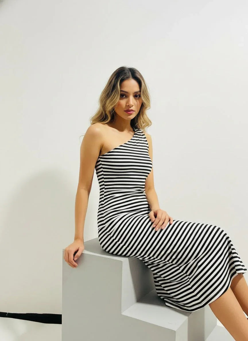 Woman wearing a black and white striped one-shoulder dress, Aroka Life fashion