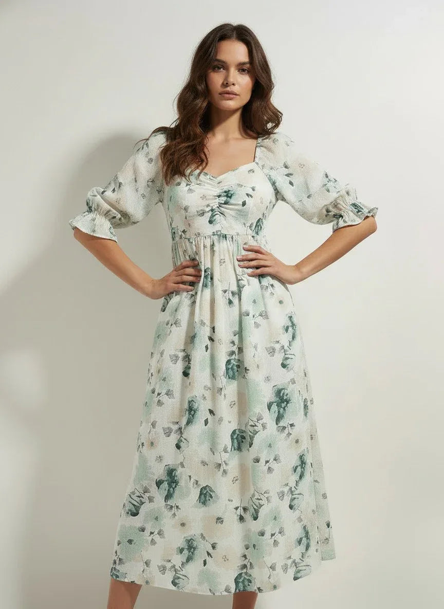 Woman wearing a light floral midi dress with puff sleeves from Aroka Life New Zealand fashion