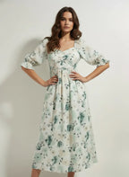 Woman wearing a light floral midi dress with puff sleeves from Aroka Life New Zealand fashion