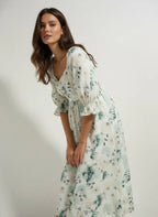 Woman in a light floral midi dress, styled for Aroka Life New Zealand fashion collection