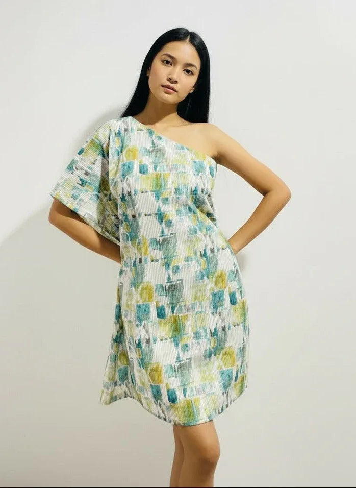 Woman modeling ArokaLife one-shoulder printed dress, modern New Zealand fashion style