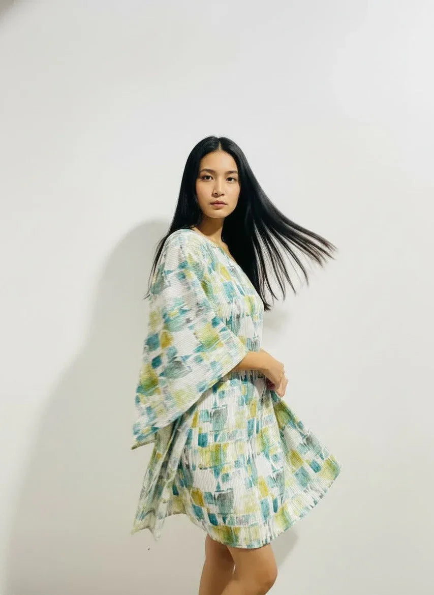 Woman in a flowy, abstract print dress from Aroka Life, modern New Zealand fashion